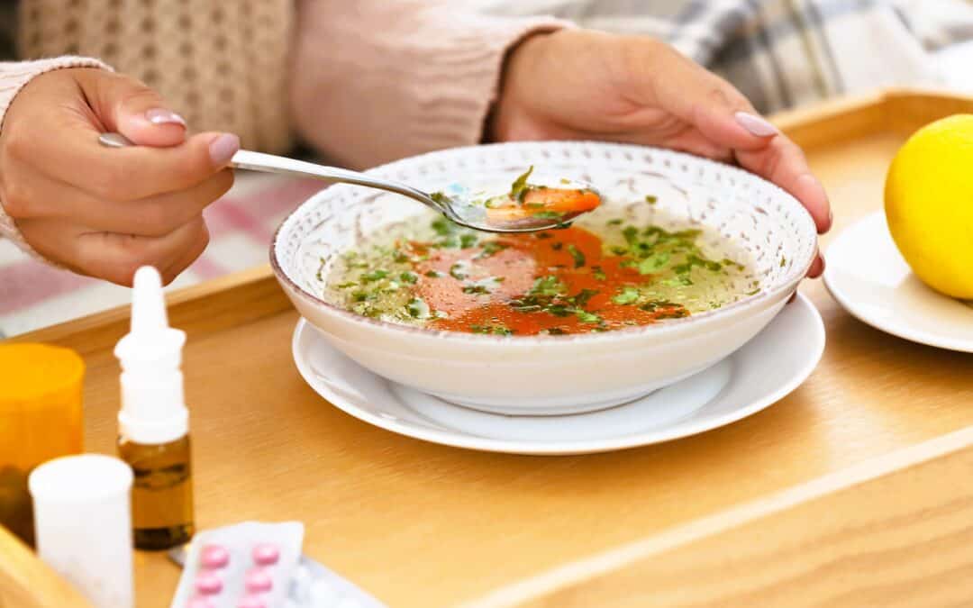 woman-eating-soup-with-medicine-on-tray